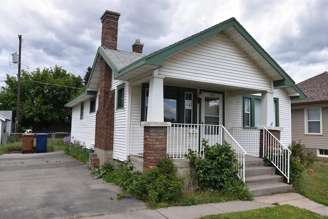 1103 E Longfellow Ave, Spokane, WA 99207 - bungalow with a chimney, a porch, and roof with shingles