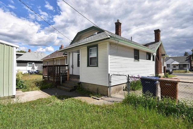 1103 E Longfellow Ave, Spokane, WA 99207 - view of side of home with a gate and a chimney