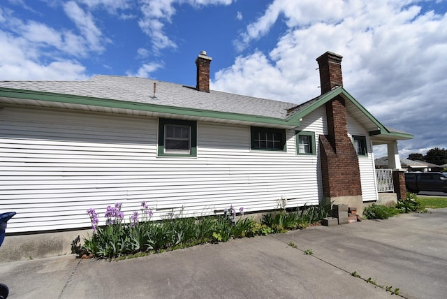 1103 E Longfellow Ave, Spokane, WA 99207 - view of side of home with a chimney