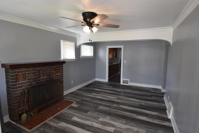 1103 E Longfellow Ave, Spokane, WA 99207 - unfurnished living room featuring arched walkways, ornamental molding, a ceiling fan, a fireplace, and dark wood-style flooring