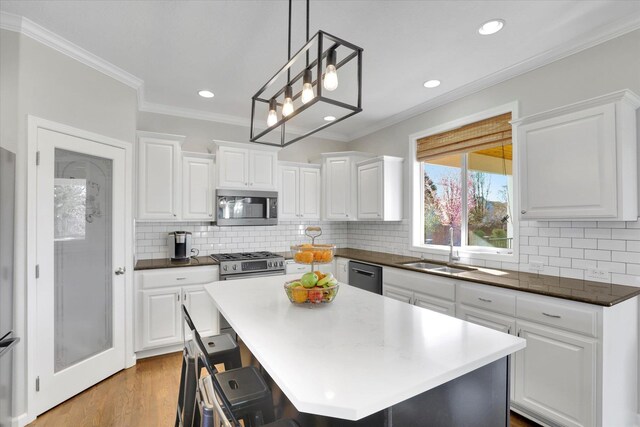 17321 E Morningside Ln, Spokane Valley, WA 99016 - kitchen with stainless steel appliances, a sink, recessed lighting, white cabinets, and ornamental molding