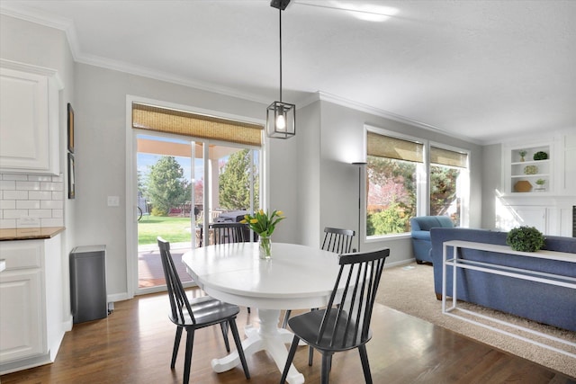 17321 E Morningside Ln, Spokane Valley, WA 99016 - dining room featuring dark wood-style floors, healthy amount of natural light, ornamental molding, and baseboards