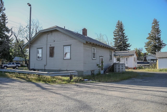 2208 N Park Rd, Spokane Valley, WA 99212 - view of side of home featuring a chimney