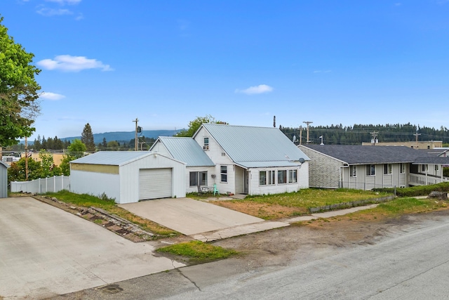110 N Spokane Ave, Newport, WA 99156 - ranch-style house with metal roof, a garage, and concrete driveway