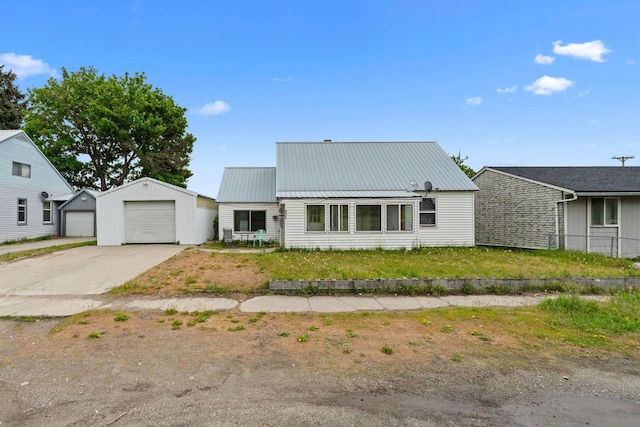 110 N Spokane Ave, Newport, WA 99156 - view of front of home with a garage, an outbuilding, metal roof, and driveway