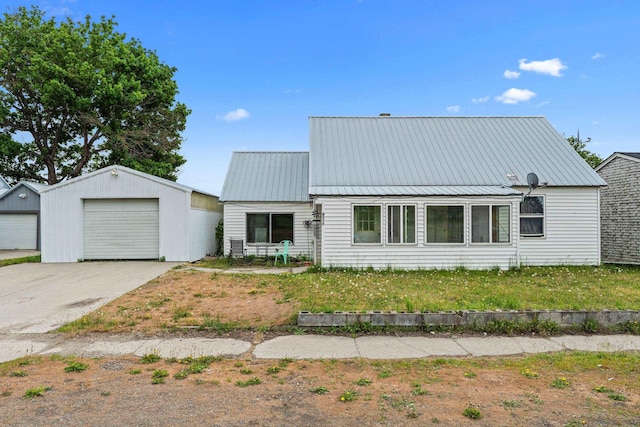 110 N Spokane Ave, Newport, WA 99156 - view of front of home with an outdoor structure, a detached garage, and metal roof