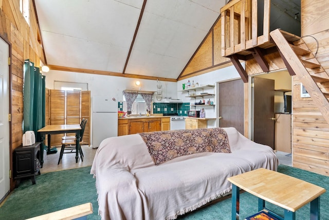 6500 W Soledad Ln, Cheney, WA 99004 - living area featuring a wood stove, wooden walls, and high vaulted ceiling