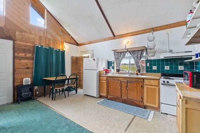 6500 W Soledad Ln, Cheney, WA 99004 - kitchen featuring white appliances, wood walls, a wood stove, light countertops, and high vaulted ceiling