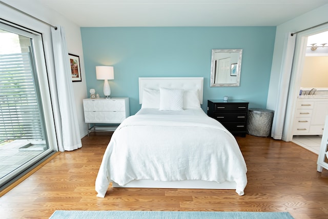 136 E Rockwood Blvd Unit 201, Spokane, WA 99202 - bedroom with wood finished floors, access to exterior, and ensuite bath