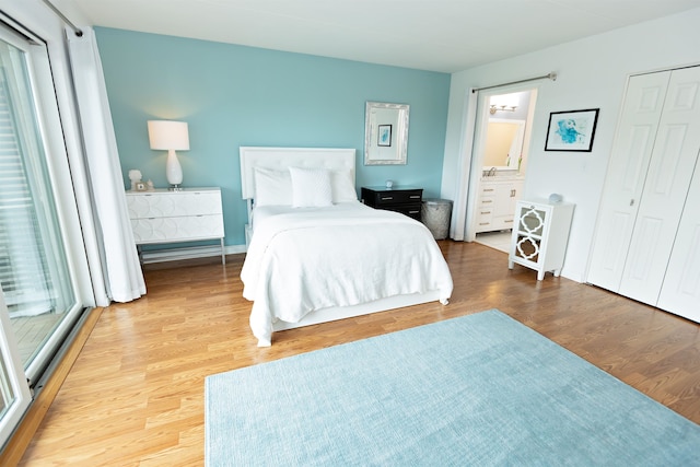 136 E Rockwood Blvd Unit 201, Spokane, WA 99202 - bedroom featuring wood finished floors and ensuite bath