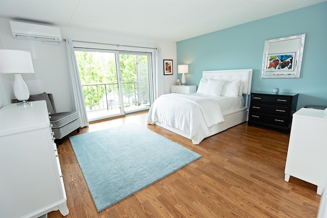 136 E Rockwood Blvd Unit 201, Spokane, WA 99202 - bedroom featuring a wall mounted AC, access to exterior, and wood finished floors