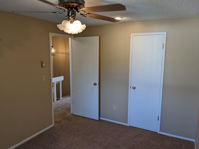7878 N Wilding Dr Unit 14, Spokane, WA 99208 - unfurnished bedroom with carpet flooring, a textured ceiling, ceiling fan, and baseboards