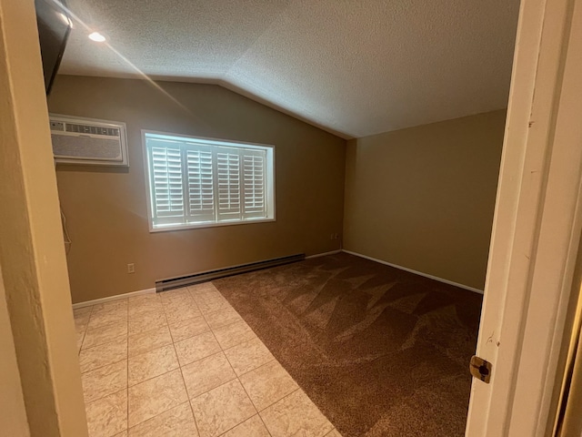 7878 N Wilding Dr Unit 14, Spokane, WA 99208 - additional living space with baseboard heating, vaulted ceiling, a textured ceiling, a wall mounted air conditioner, and baseboards