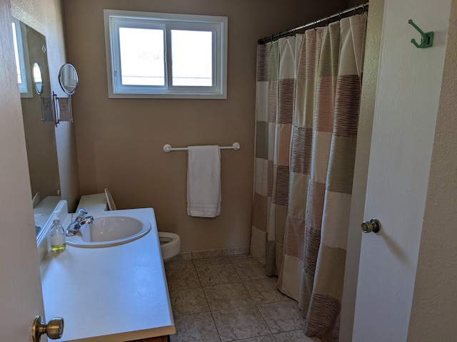 7878 N Wilding Dr Unit 14, Spokane, WA 99208 - bathroom with toilet, vanity, tile patterned flooring, and a shower with curtain