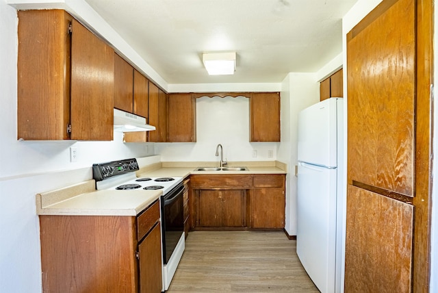 16108 E Broadway Avenue 16110E Broadway Ave, Spokane Valley, WA 99037 - kitchen with freestanding refrigerator, electric range oven, a sink, under cabinet range hood, and brown cabinets
