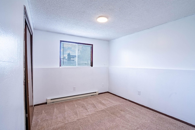 16108 E Broadway Avenue 16110E Broadway Ave, Spokane Valley, WA 99037 - unfurnished bedroom featuring a baseboard heating unit, carpet flooring, a textured ceiling, and baseboards