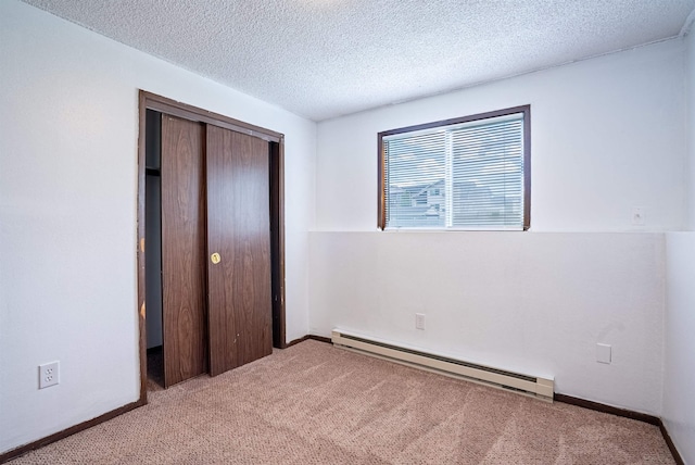16108 E Broadway Avenue 16110E Broadway Ave, Spokane Valley, WA 99037 - unfurnished bedroom with baseboard heating, carpet floors, a closet, a textured ceiling, and baseboards