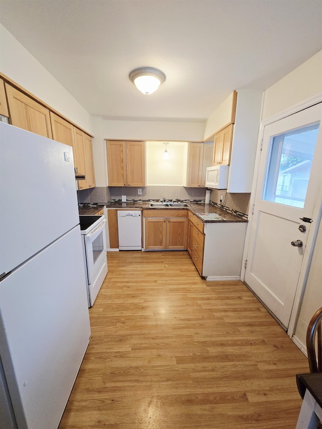 1304 E Hoffman Ave, Spokane, WA 99207 - kitchen featuring white appliances, light brown cabinetry, dark countertops, light wood-style flooring, and a sink