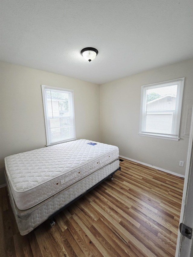 1304 E Hoffman Ave, Spokane, WA 99207 - bedroom with wood finished floors and baseboards