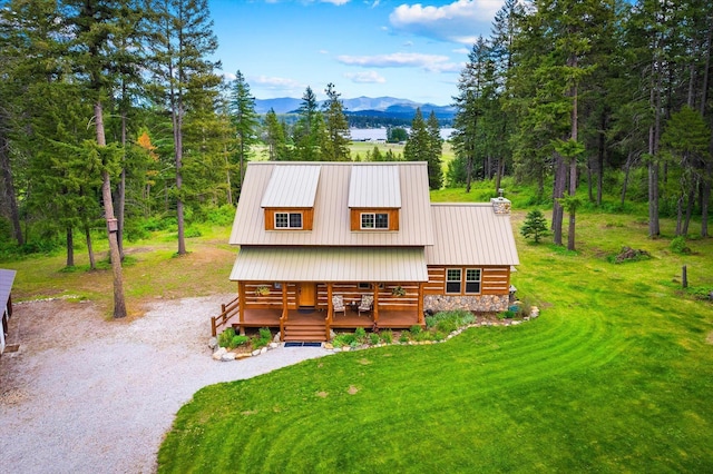 3475B Waitts Lake Rd, Valley, WA 99181 - rear view of house with a mountain view, covered porch, a chimney, metal roof, and driveway