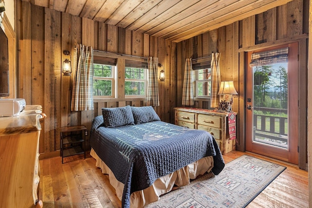 3475B Waitts Lake Rd, Valley, WA 99181 - bedroom featuring wood walls, access to exterior, multiple windows, light wood finished floors, and wood ceiling