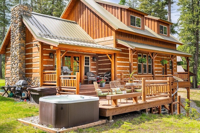 3475B Waitts Lake Rd, Valley, WA 99181 - rear view of house featuring a hot tub, a chimney, cooling unit, metal roof, and a wooden deck