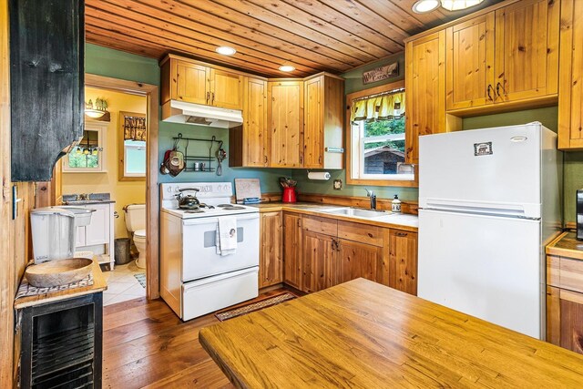 3475B Waitts Lake Rd, Valley, WA 99181 - kitchen with white appliances, under cabinet range hood, a sink, wooden ceiling, and recessed lighting