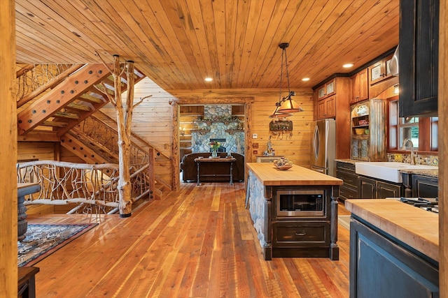 3475B Waitts Lake Rd, Valley, WA 99181 - kitchen with wood counters, stainless steel appliances, a sink, wood ceiling, and wooden walls