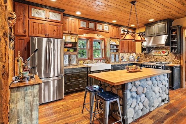 3475B Waitts Lake Rd, Valley, WA 99181 - kitchen with freestanding refrigerator, butcher block counters, a sink, under cabinet range hood, and wood ceiling