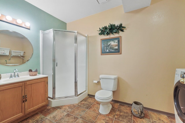 15314 N Gleneden St, Spokane, WA 99208 - bathroom featuring vanity, a stall shower, washer / dryer, toilet, and baseboards