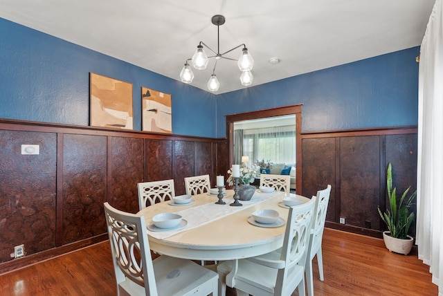 1116 E Newark Ave, Spokane, WA 99202 - dining space featuring wood finished floors, a chandelier, and wainscoting