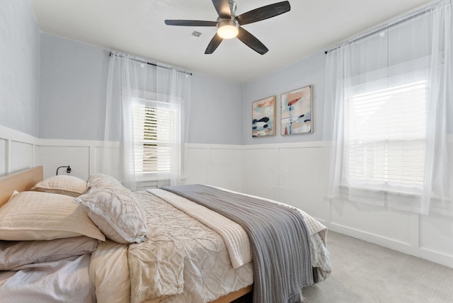 1116 E Newark Ave, Spokane, WA 99202 - bedroom featuring light colored carpet, wainscoting, a ceiling fan, and a decorative wall