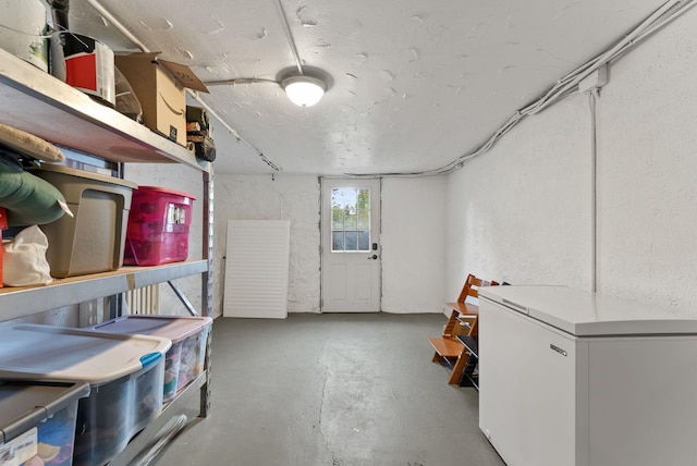 1116 E Newark Ave, Spokane, WA 99202 - basement featuring fridge and a textured wall