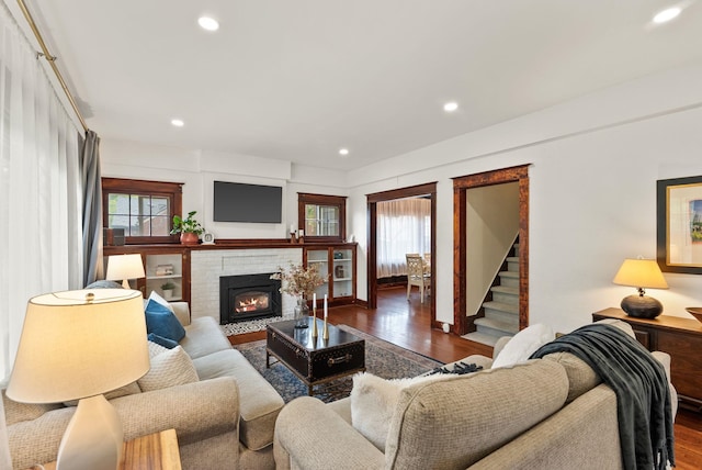 1116 E Newark Ave, Spokane, WA 99202 - living area featuring wood finished floors, healthy amount of natural light, recessed lighting, a brick fireplace, and stairs