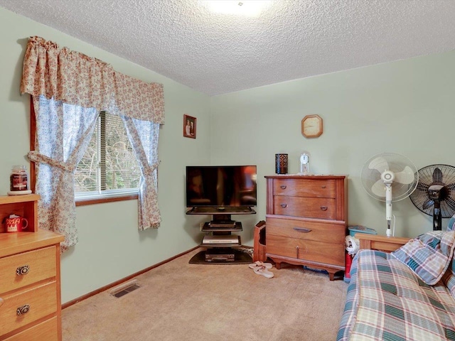 11723 S Player Dr, Spokane, WA 99223 - bedroom featuring carpet floors, a textured ceiling, and baseboards