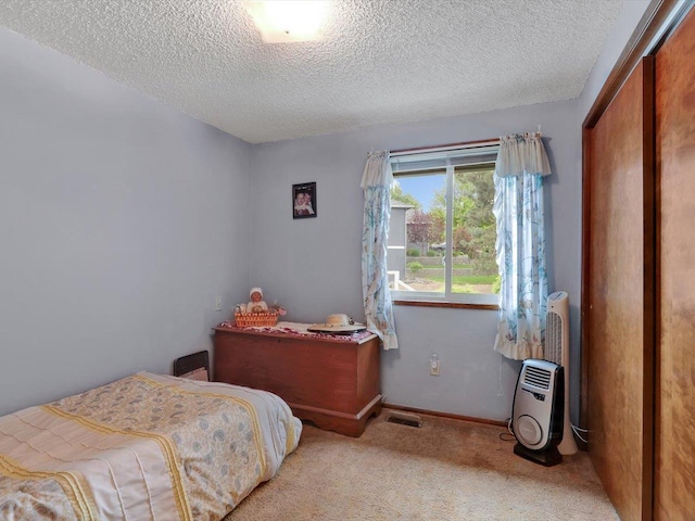 11723 S Player Dr, Spokane, WA 99223 - carpeted bedroom with a textured ceiling, a closet, and baseboards
