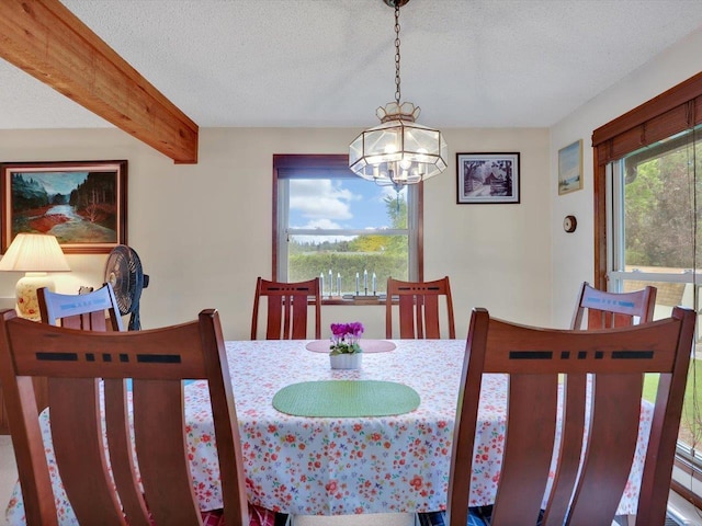 11723 S Player Dr, Spokane, WA 99223 - dining space featuring a chandelier, a textured ceiling, and beamed ceiling