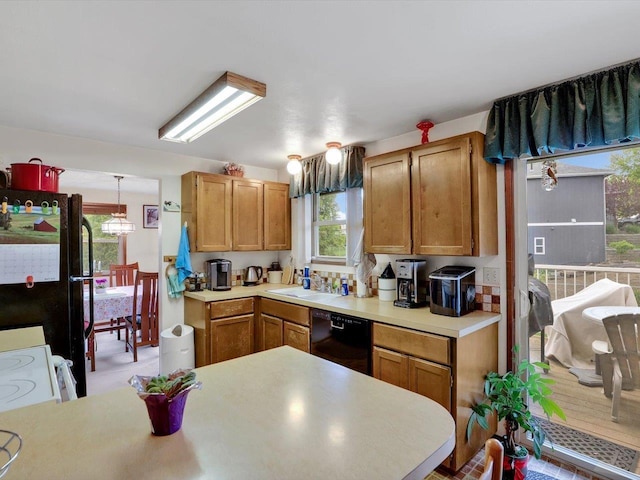 11723 S Player Dr, Spokane, WA 99223 - kitchen with dishwasher, light countertops, a sink, pendant lighting, and brown cabinetry