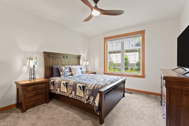 4461 W Greenchain Loop # 5, Coeur D Alene, ID 83814 - bedroom featuring baseboards, light carpet, and a ceiling fan