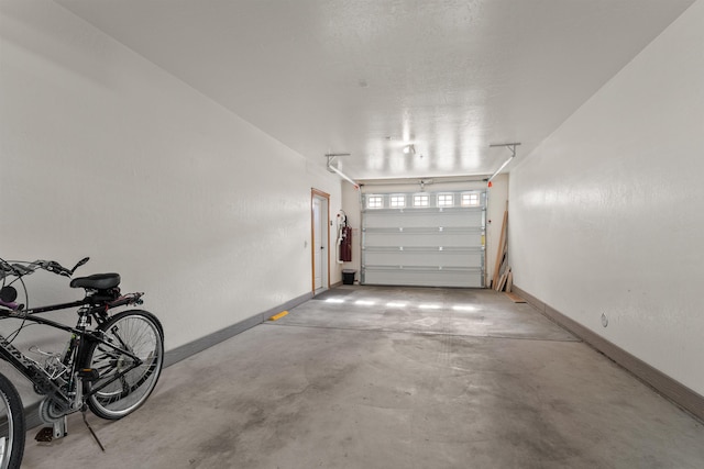 4461 W Greenchain Loop # 5, Coeur D Alene, ID 83814 - garage featuring baseboards and a central vacuum unit