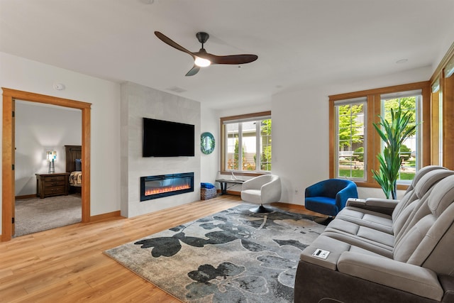 4461 W Greenchain Loop # 5, Coeur D Alene, ID 83814 - living area with ceiling fan, a fireplace, light wood finished floors, and baseboards