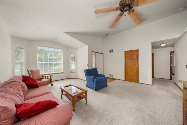 23019 E Remington Ln, Liberty Lake, WA 99019 - living area with light carpet, vaulted ceiling, a ceiling fan, and baseboards