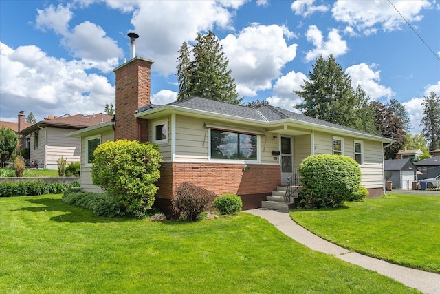 4218 N E St, Spokane, WA 99205 - view of front facade with a front yard, brick siding, and a chimney