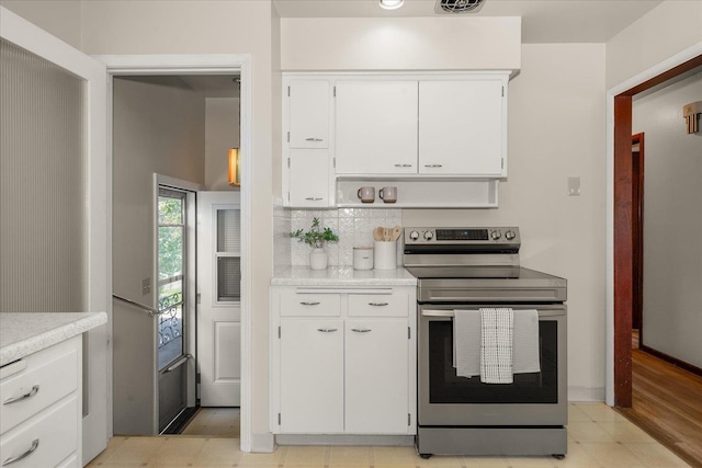 4218 N E St, Spokane, WA 99205 - kitchen featuring stainless steel electric range oven, white cabinetry, light countertops, and backsplash