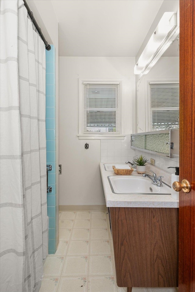 4218 N E St, Spokane, WA 99205 - bathroom featuring vanity, baseboards, and a shower with curtain