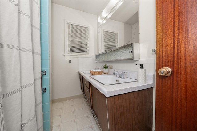 4218 N E St, Spokane, WA 99205 - full bathroom with vanity, tasteful backsplash, tile patterned floors, and curtained shower