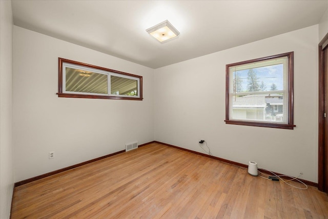4218 N E St, Spokane, WA 99205 - spare room featuring baseboards and light wood-style flooring