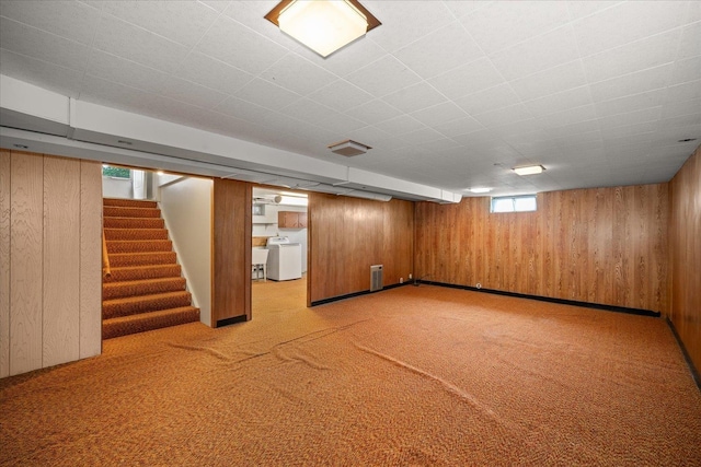 4218 N E St, Spokane, WA 99205 - below grade area with light colored carpet, wooden walls, stairway, and washer and clothes dryer