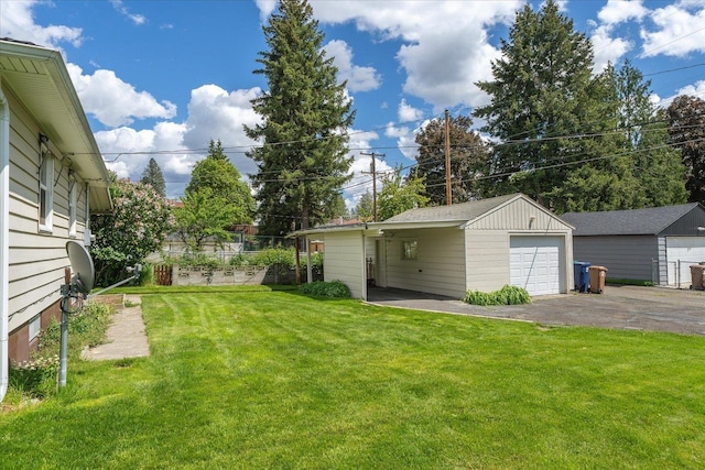 4218 N E St, Spokane, WA 99205 - view of green lawn featuring driveway, a garage, and an outdoor structure