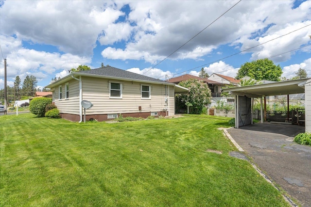 4218 N E St, Spokane, WA 99205 - rear view of house with a yard, asphalt driveway, and a detached carport